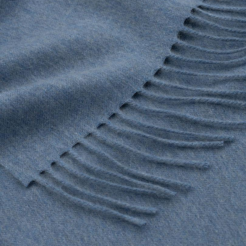 Close-up of a textured blue fabric with a patterned edge