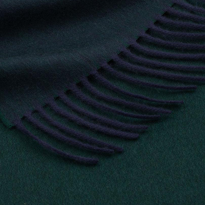 Dark green fabric with a fringe detail